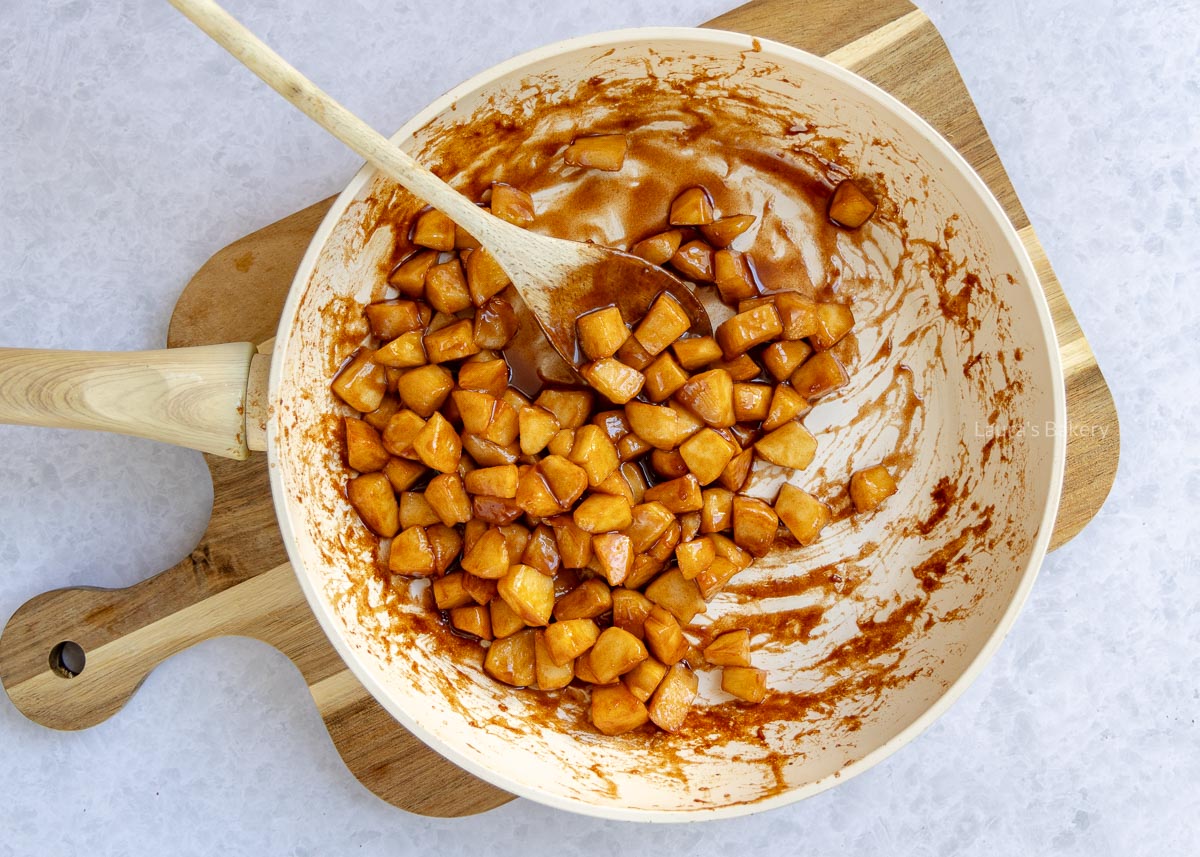 Gekarameliseerde stukjes appel in de koekenpan